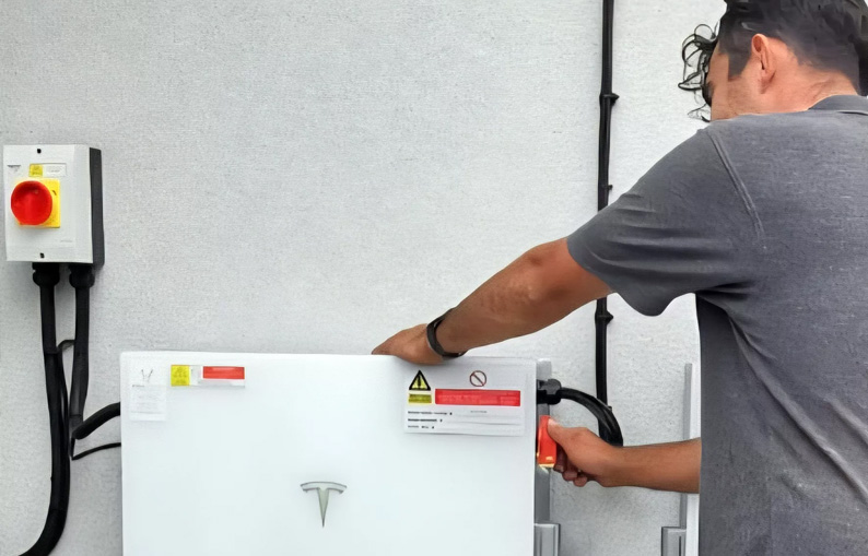 Man installing Tesla Powerwall.